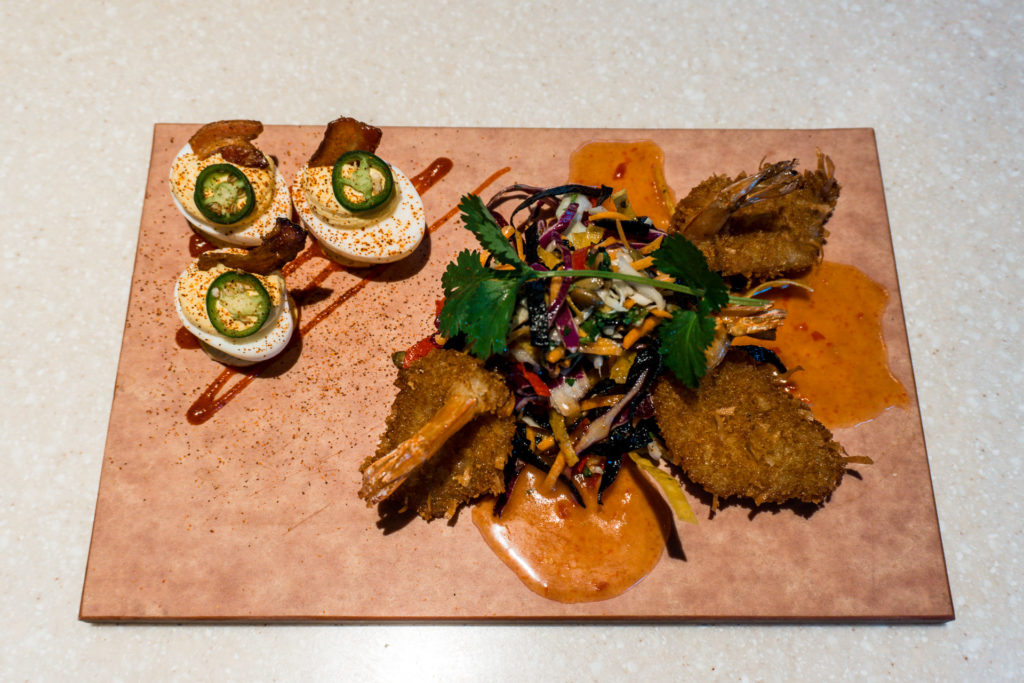 Appetizers at Firebird's Grill. Top left jalapeno deviled eggs. Bottom right coconut shrimp with cabbage slaw.
