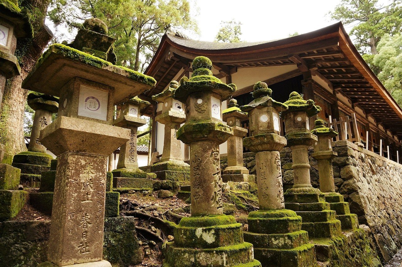 Japanese stone lanterns covered in green moss