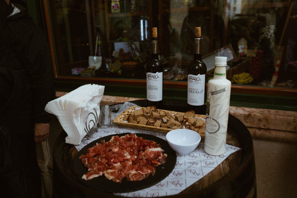 Sampling of bread, cheese, cured ham, and wine from the Taste of Lisboa food tour