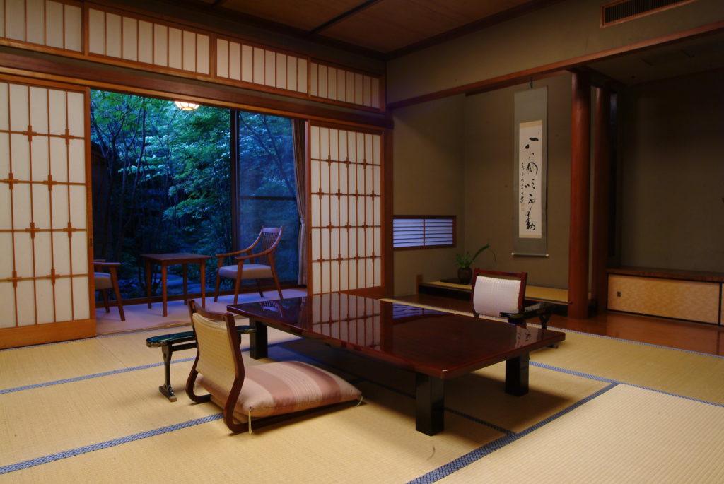 View of the garden area and open-air bath from the living space in the Hatsune Room at Nishimuraya Honkan.